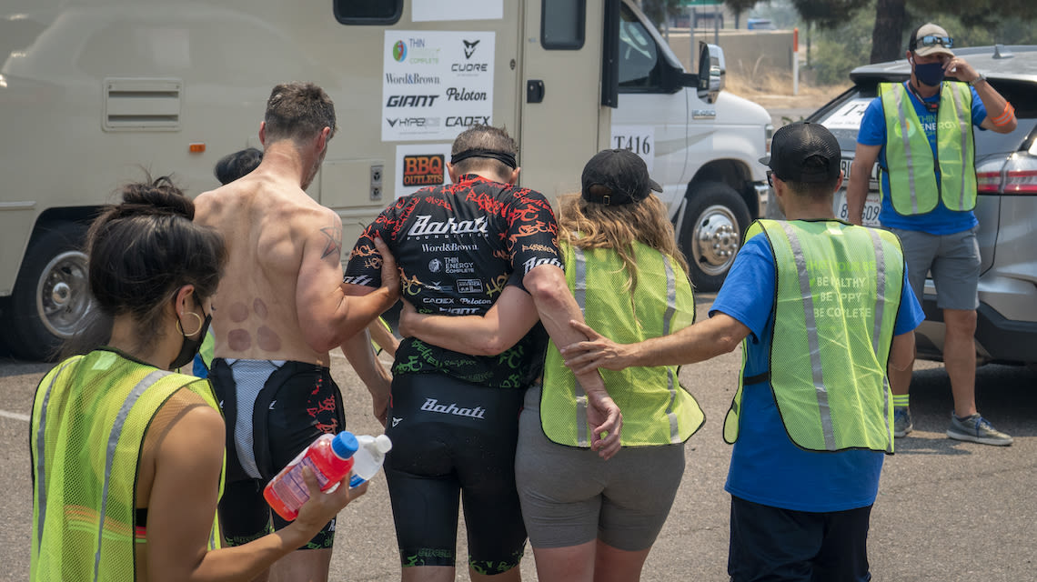 Team Thin Energy rider Alex Isaly is tended to by teammates and medics after suffering through extreme heat in the 2021 Race Across America.